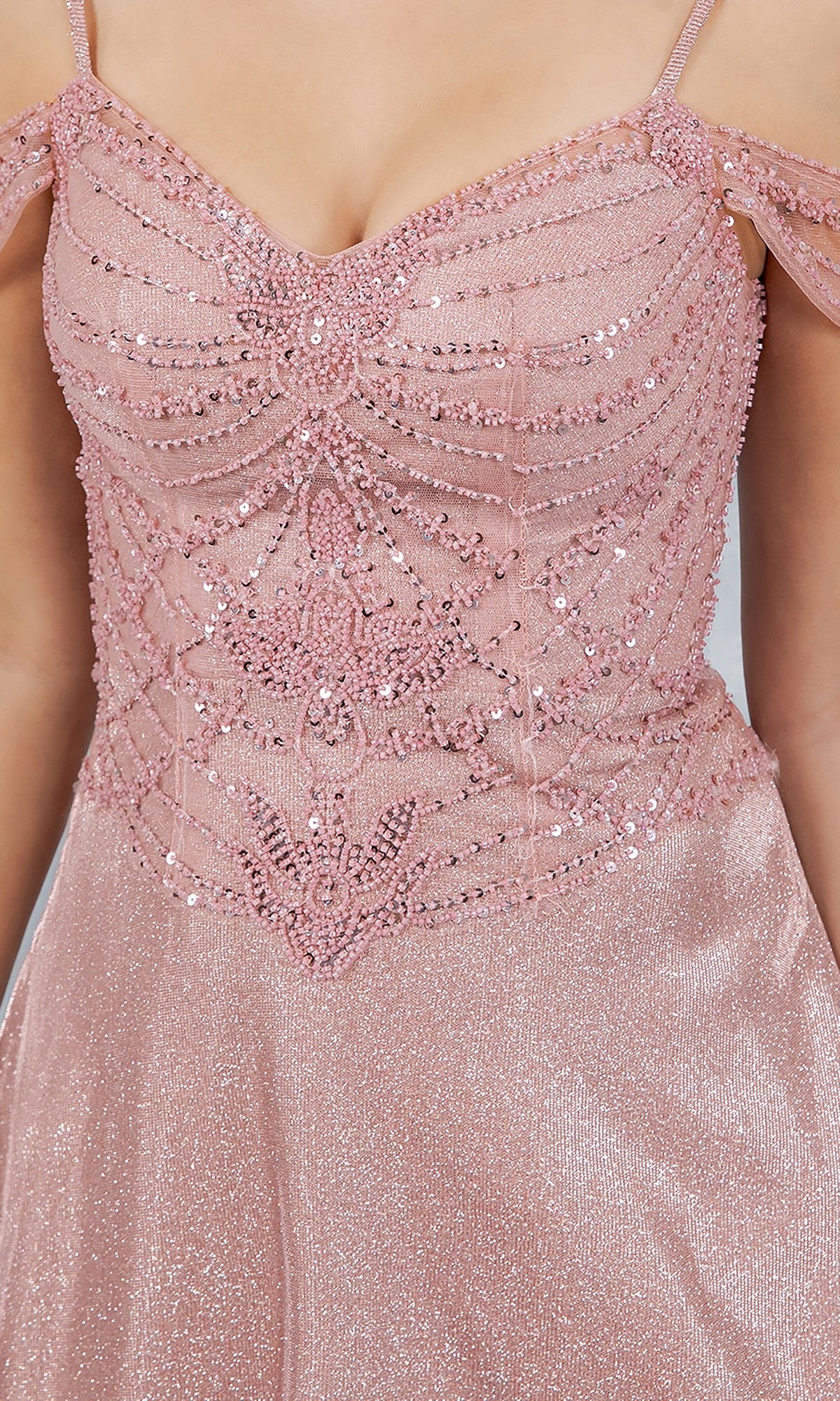Close-up of the Long Prom Dress: Cinderella Couture 8581J in pink glitter, featuring thin straps, a beaded bodice with intricate detailing, and off-the-shoulder draped accents.